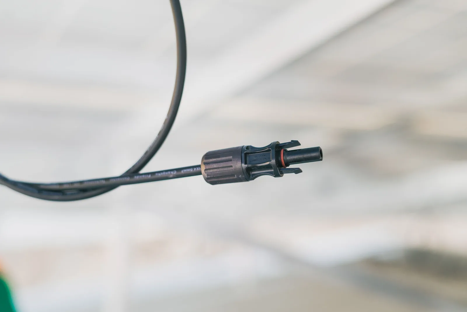 Detailed close-up shot of an electrical connector cable with a blurred background. Coastal or continental, choosing garden sensors for Canadian microclimates